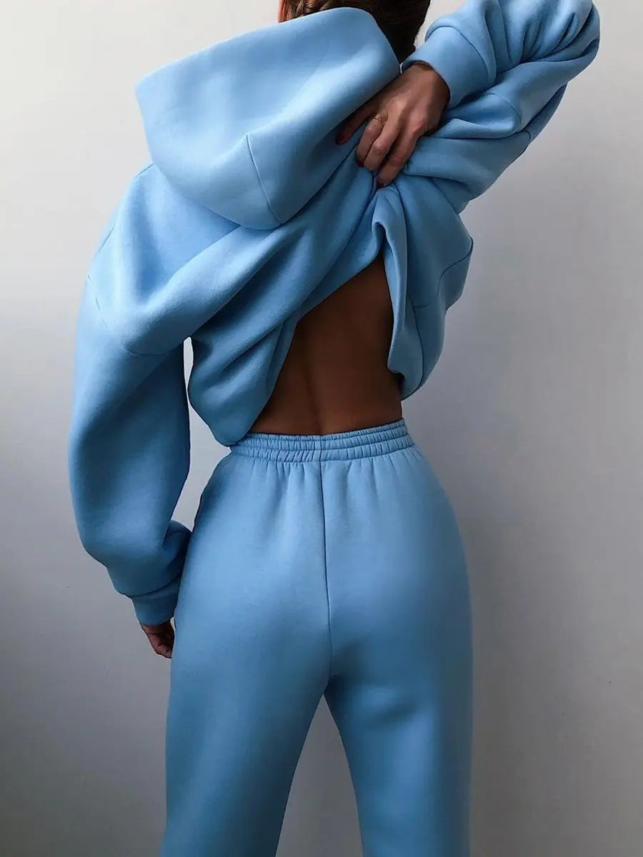 High-waisted blue fleece tracksuit set with oversized pullover and jogger pants, showcasing a stylish open-back detail.