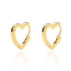 Chunky gold huggie earrings in a heart drop design with a polished finish, showcasing a minimalist aesthetic.