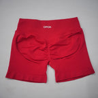 High-waisted red gym shorts featuring a scrunch-butt design and seamless fabric for a smooth fit.