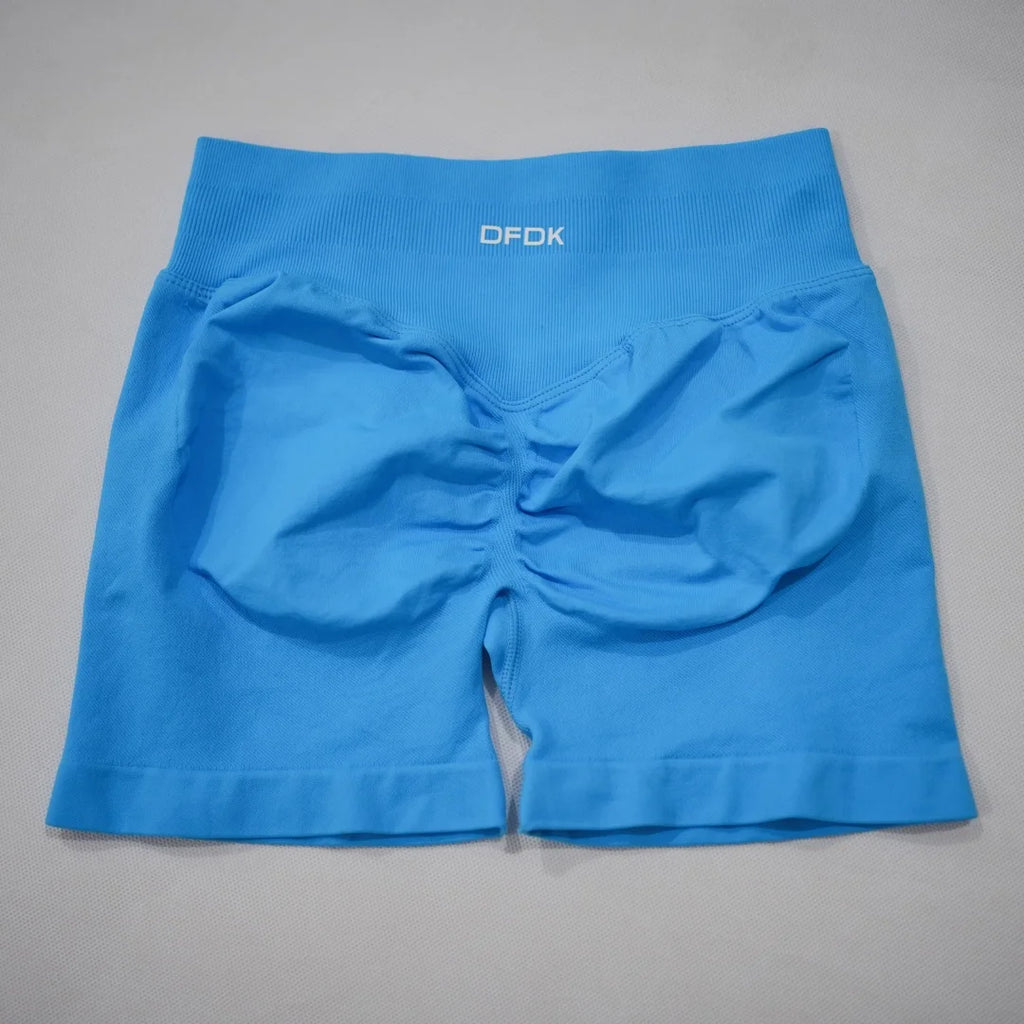 Bright blue high-waisted gym shorts with a seamless design and scrunch-butt detailing for enhanced silhouette.