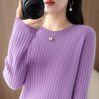 Cozy lavender pullover with ribbed texture and classic O-neck, worn casually with a gold necklace and earrings.