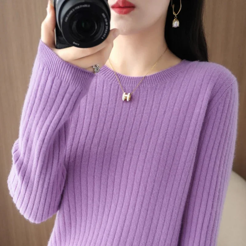 Cozy lavender pullover with ribbed texture and classic O-neck, worn casually with a gold necklace and earrings.
