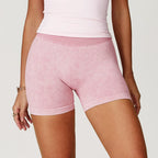 High-waisted, pink sand-washed seamless gym shorts with a soft texture and comfortable fit, perfect for workouts.