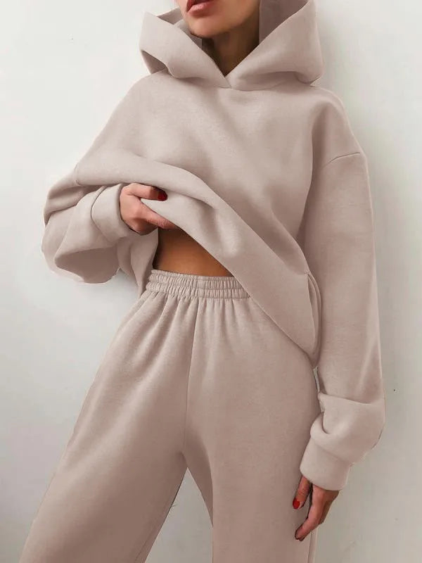 Cozy beige high-waisted tracksuit set featuring an oversized hoodie and jogger pants with elastic waistband.