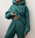 Premium fleece tracksuit set in teal featuring an oversized hoodie and high-waisted joggers, styled for a cozy fit.