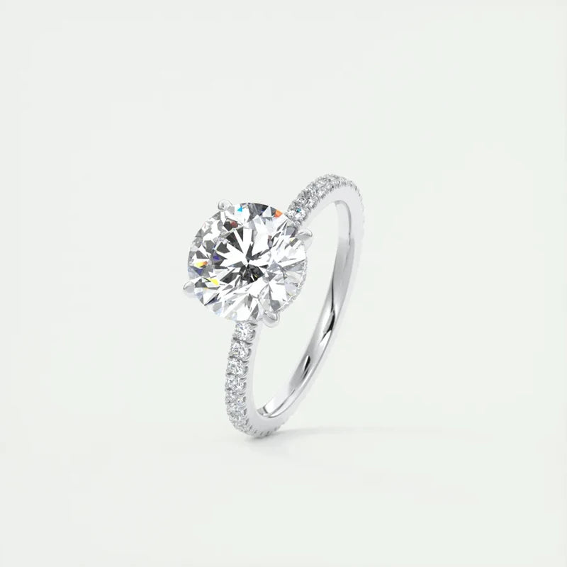 A 2-carat round-cut Moissanite solitaire ring in 925 sterling silver with a sleek band and sparkling accents.