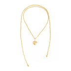 Layered gold-tone necklace featuring pearl elements and a heart pendant, designed for versatile styling.