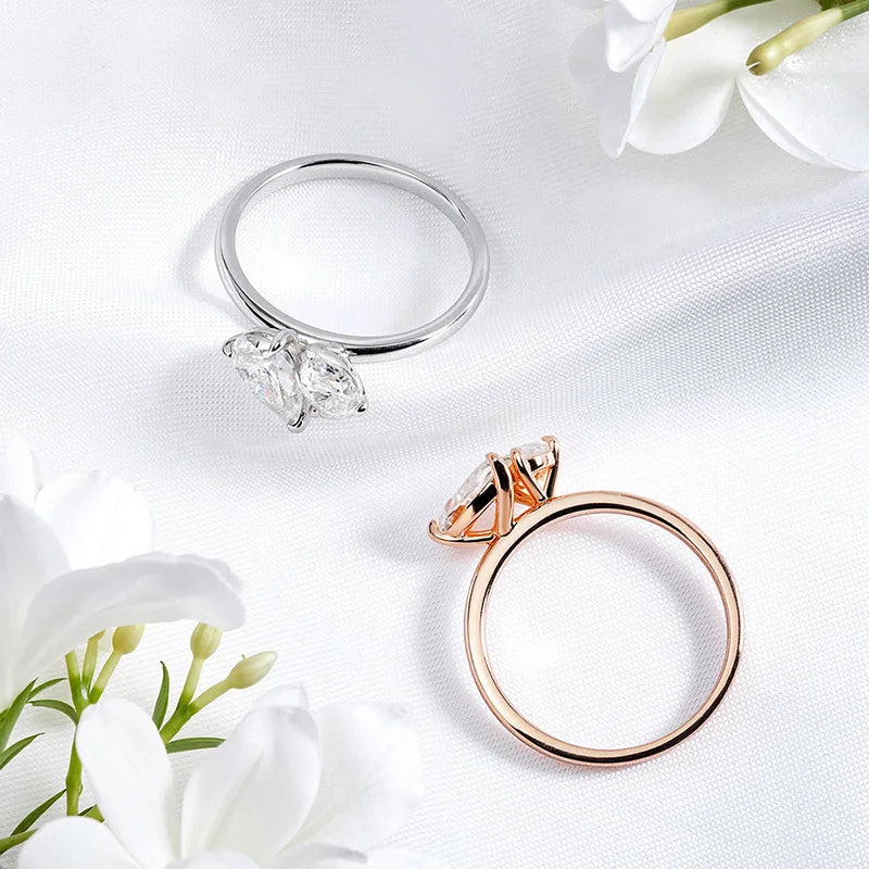 LOVORA™ Imperial Double Pear Cut Moissanite Statement Ring in silver and rose gold, featuring two pear-cut gemstones on a sleek band.