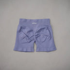 High-waisted gym shorts in light lavender with a scrunch-butt design and a wide, ribbed waistband.
