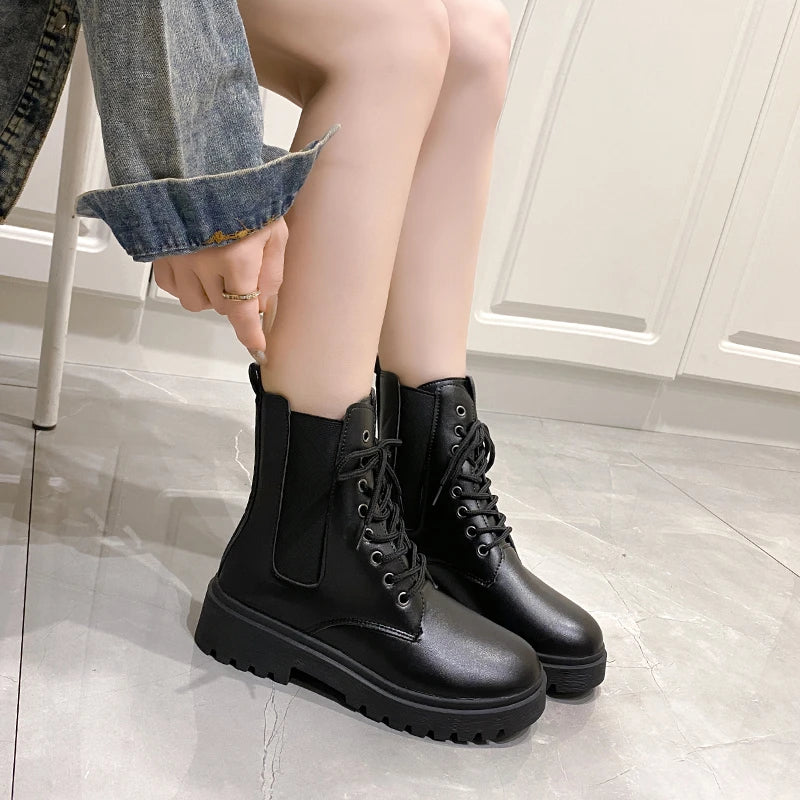 Croc-embossed black Chelsea boots with lace-up front, elastic side panels, and chunky platform soles.