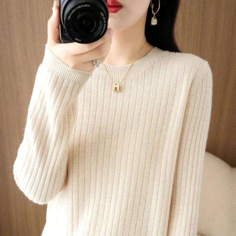 Cozy cream-colored LOVORA™ Classic Striped O-Neck pullover with ribbed texture, worn by a model holding a camera.