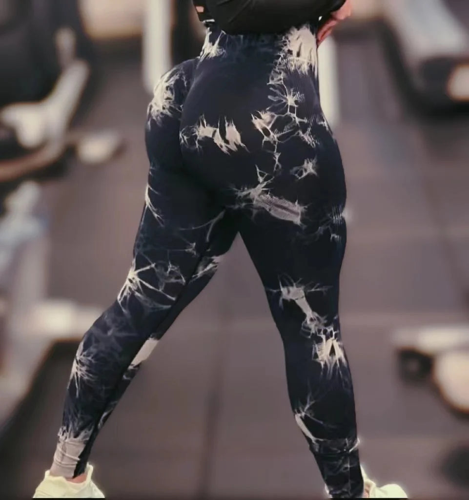 High-waisted leggings in a dark blue and white tie-dye pattern, featuring a seamless design and contour detailing.