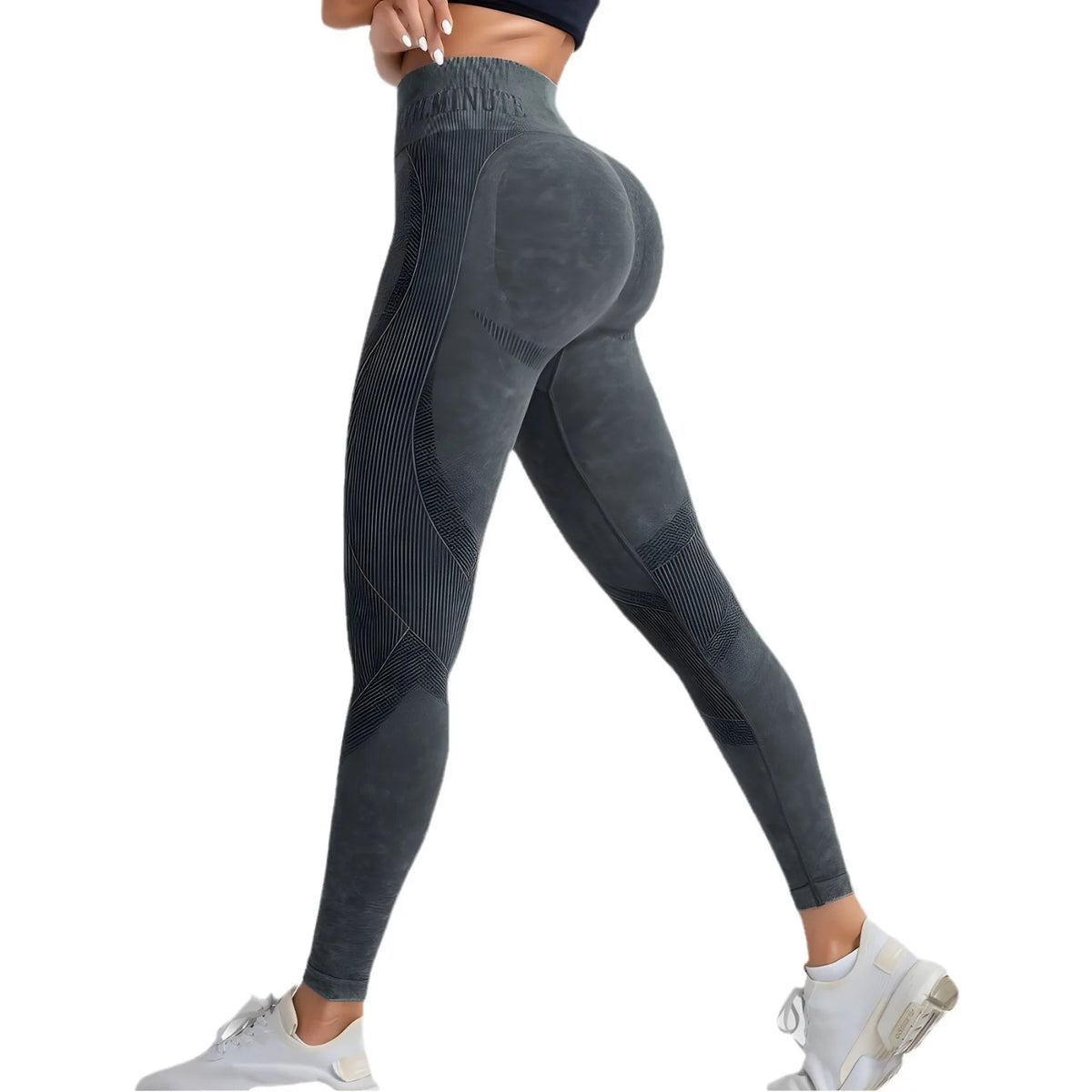 High-waisted, sand-washed leggings in dark gray with subtle line patterns, showcased on a model wearing white sneakers.