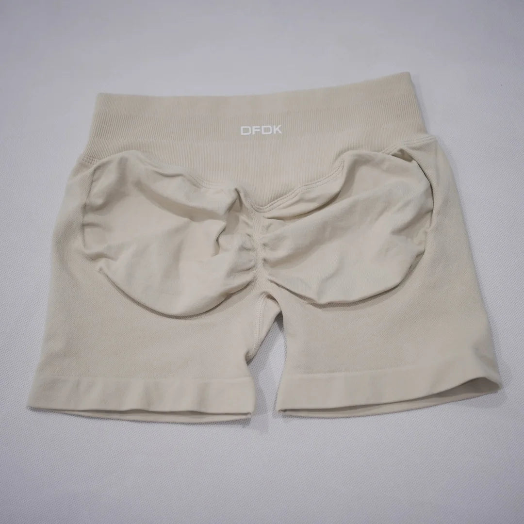 Beige LOVORA™ Sculpt & Lift Seamless High-Waisted Gym Shorts with a scrunch-butt design and wide waistband for tummy control.