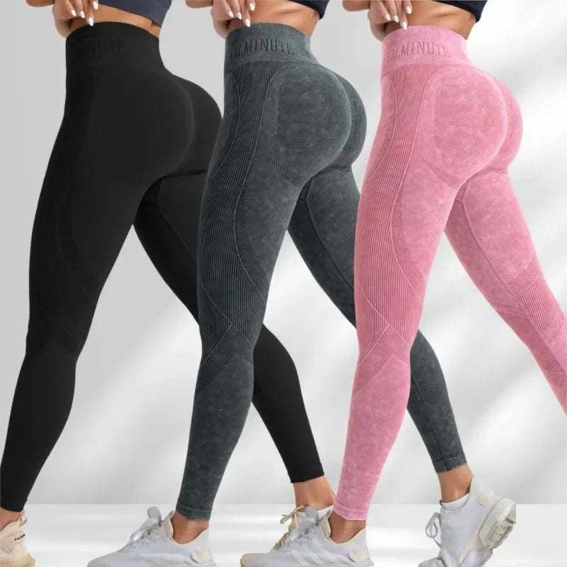 High-waisted seamless leggings in black, dark gray, and pink with a sand-washed texture and supportive fit.