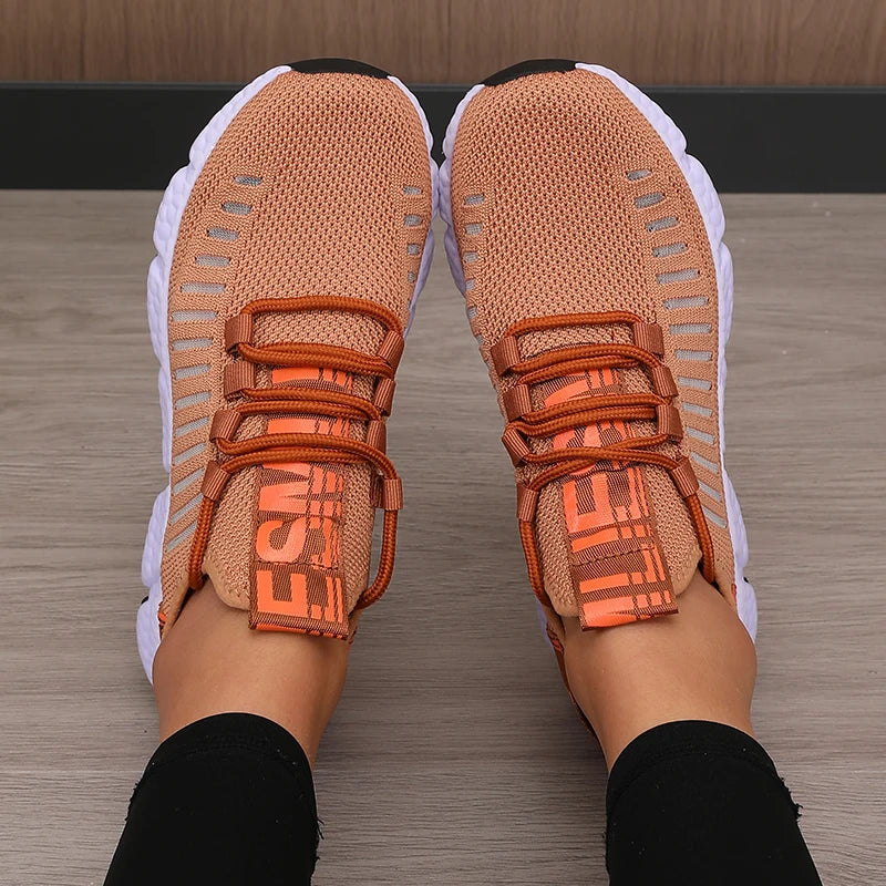Lightweight knitted performance sneakers in a warm peach color, featuring lace-up design and breathable mesh.
