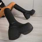 Ultra-chunky black eco-leather boots with a sculpted block heel and elevated platform, perfect for bold streetwear.