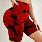 High-waisted gym shorts in a bold red and black tie-dye pattern, featuring a seamless fit and snug waistband.