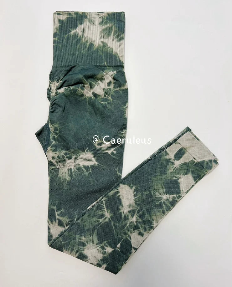 High-waisted leggings in a green tie-dye pattern with a wide waistband, crafted from a seamless nylon-spandex blend.