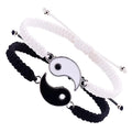 Braided couple bracelets in black and white with interlocking Yin Yang symbols, featuring adjustable nylon cords.