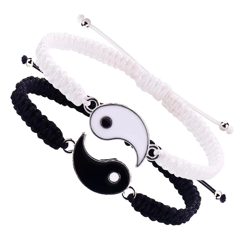 Braided couple bracelets in black and white with interlocking Yin Yang symbols, featuring adjustable nylon cords.