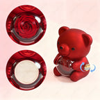 Luxury red display featuring a sculpted rose and a charming red teddy bear holding a transparent sphere.