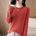 Cozy red ribbed pullover with a crewneck collar, showcasing relaxed fit and soft knit material, styled with a gold necklace.