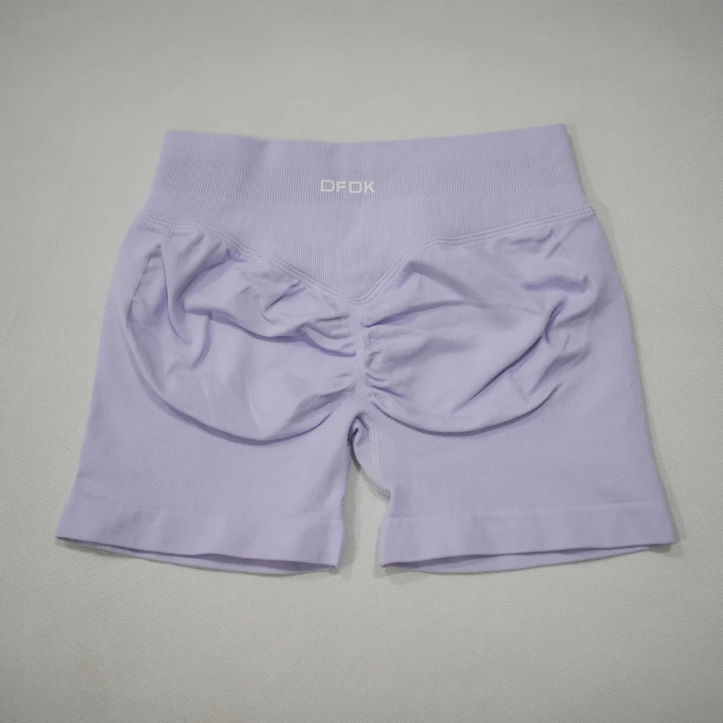 High-waisted gym shorts in light lavender, featuring a seamless design and a scrunch-butt detail for added contour.