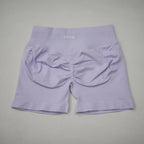 High-waisted gym shorts in light lavender, featuring a seamless design and a scrunch-butt detail for added contour.