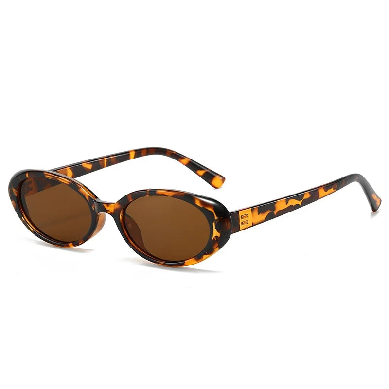 Oval sunglasses in a tortoiseshell pattern with brown lenses, featuring a sleek, minimalist design and high-polish hinges.