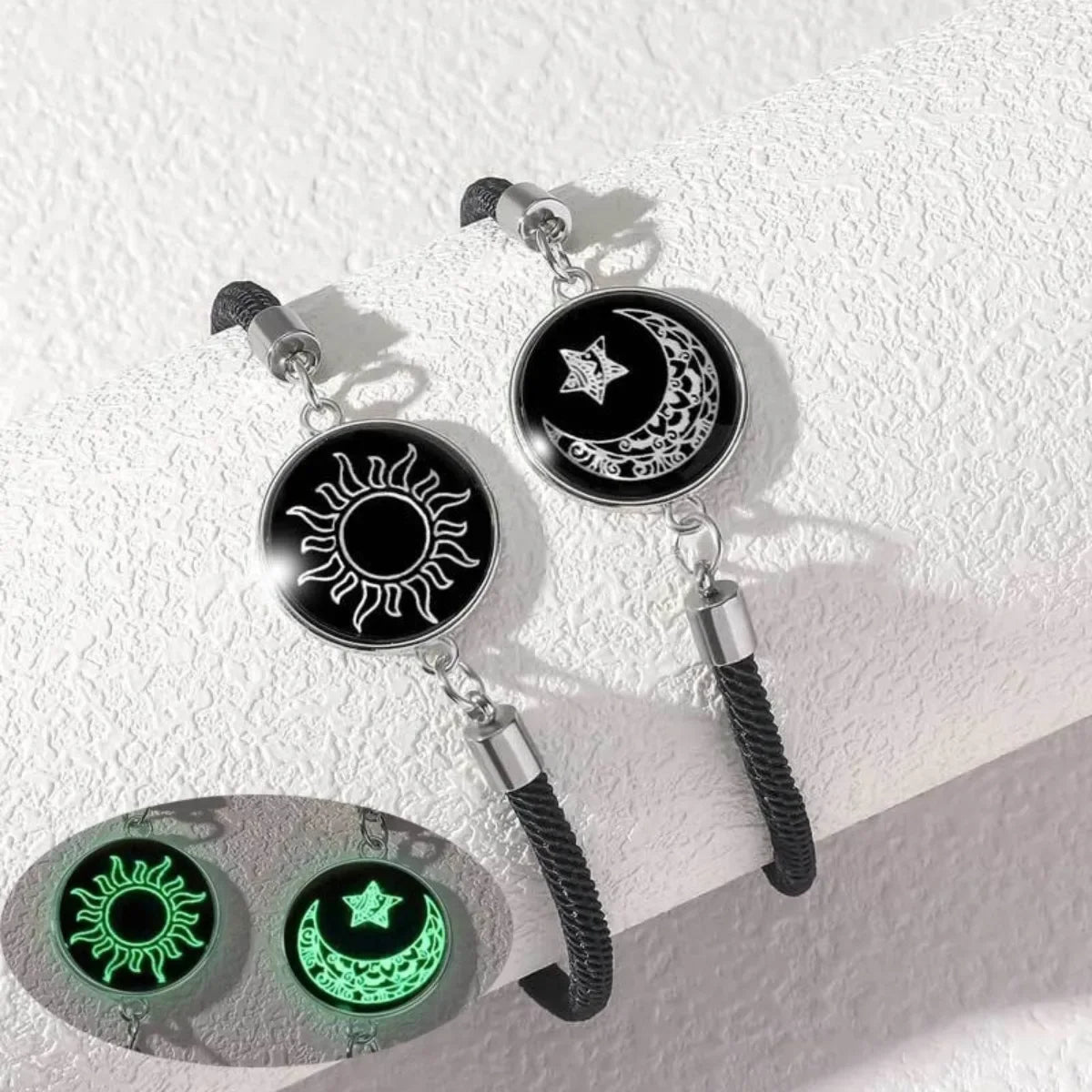 Black and silver bracelet set featuring sun and moon symbols. Glow-in-the-dark elements visible in the lower image.