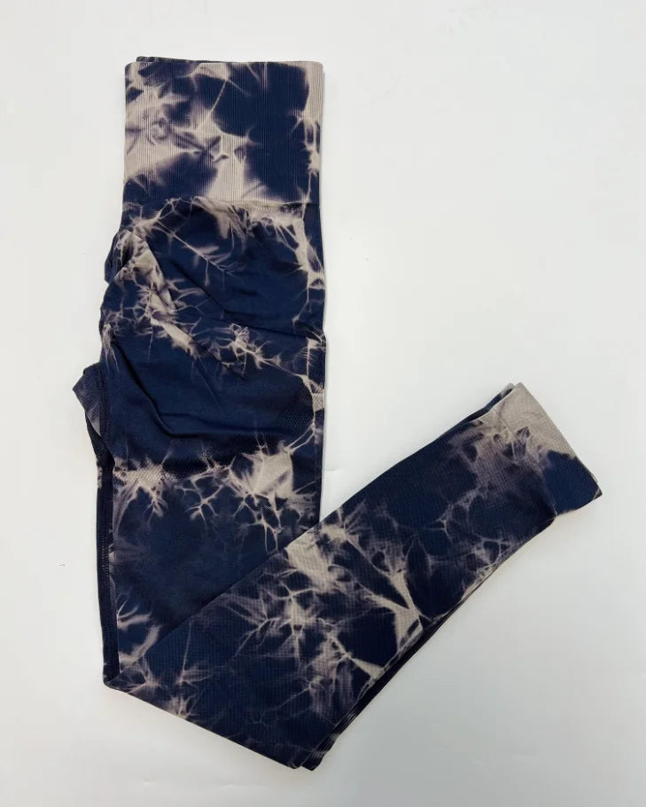High-waisted seamless leggings in navy and beige with a tie-dye pattern, featuring a wide compression waistband.