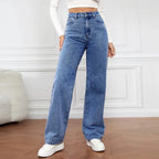 High-waisted, wide-leg denim jeans in a medium blue wash, styled with a fitted white crop top and white sneakers.
