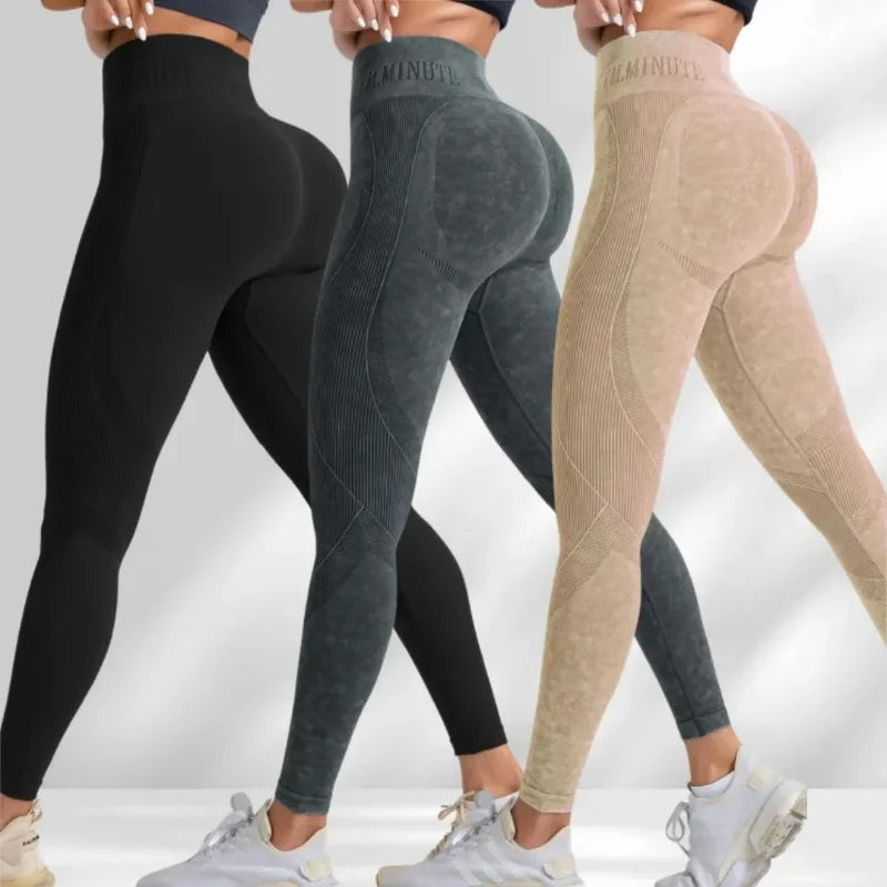 High-waisted, seamless leggings in black, dark green, and beige with a sand-washed effect and lettered branding.