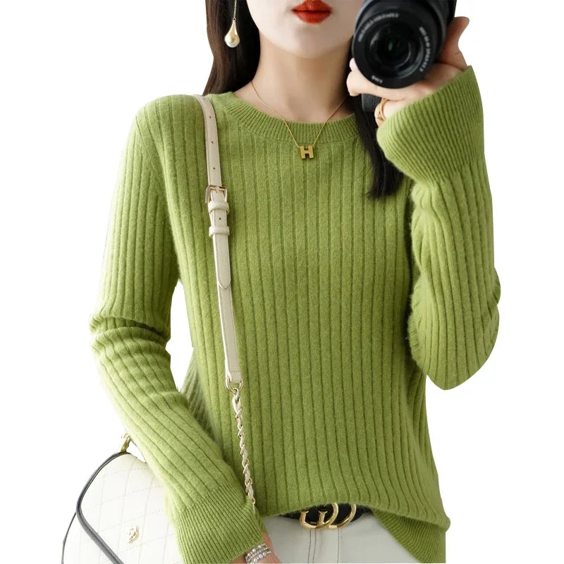 Cozy ribbed green pullover with a crewneck and relaxed fit, paired with a crossbody bag.