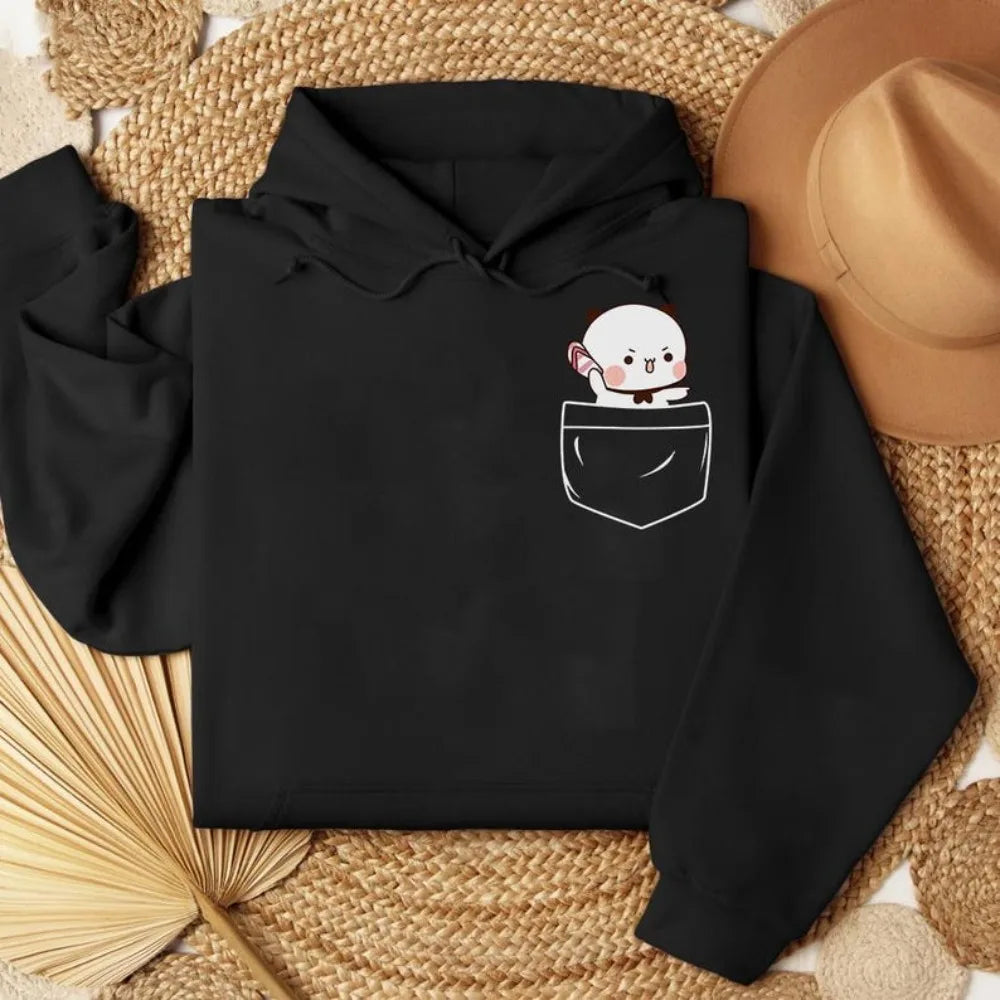 Oversized black hoodie featuring a cute cartoon bear graphic in a pocket design, made from soft cotton-fleece blend.