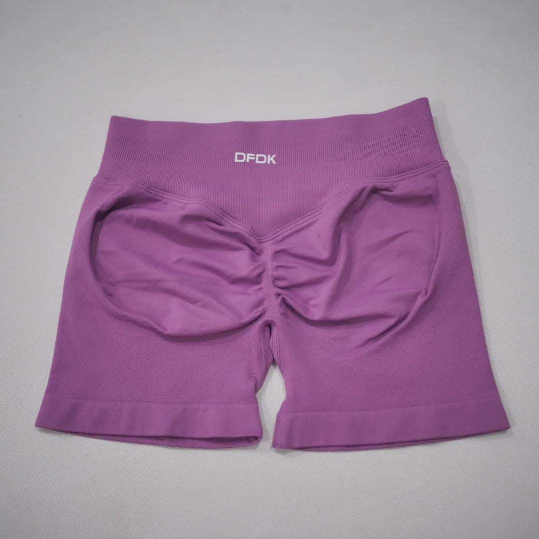 Purple seamless high-waisted gym shorts featuring a scrunch-butt design and wide elastic waistband.