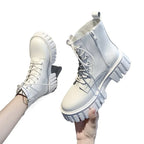 Chunky white platform combat boots with a lace-up front, zipper side, and deep-tread sole for stability and style.