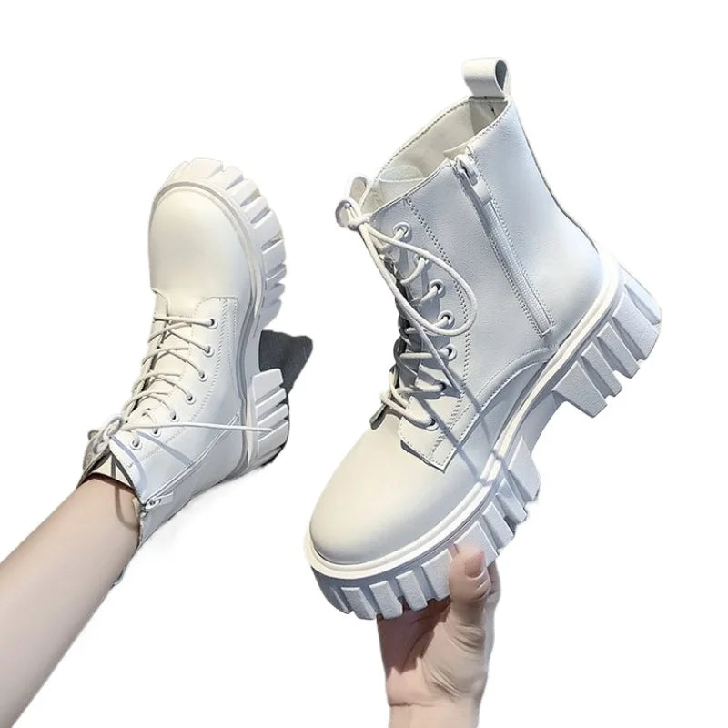 Chunky white platform combat boots with a lace-up front, zipper side, and deep-tread sole for stability and style.