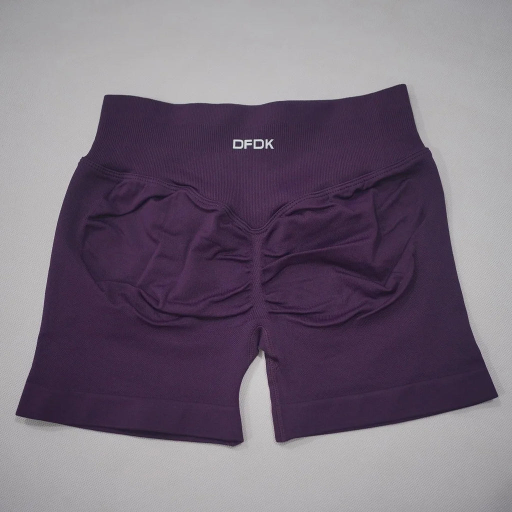 High-waisted, seamless gym shorts in deep purple with a scrunch-butt design and wide waistband for added support.