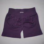 High-waisted, seamless gym shorts in deep purple with a scrunch-butt design and wide waistband for added support.