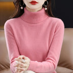 Soft pink turtleneck sweater in merino wool and cashmere blend, featuring a relaxed fit and ribbed cuffs.