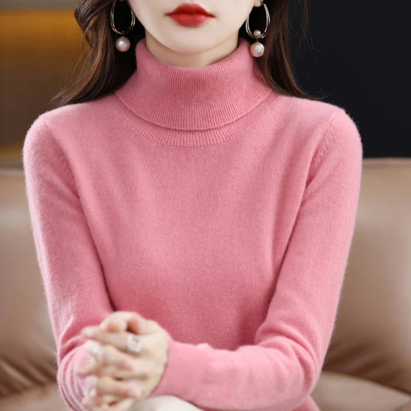 Soft pink turtleneck sweater in merino wool and cashmere blend, featuring a relaxed fit and ribbed cuffs.