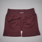 Burgundy high-waisted gym shorts with a scrunch-butt design and wide waistband, made from seamless nylon and spandex blend.