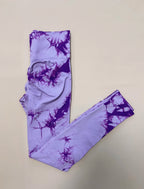High-waisted leggings in purple with a tie-dye pattern, crafted from a seamless nylon and spandex blend for comfort.