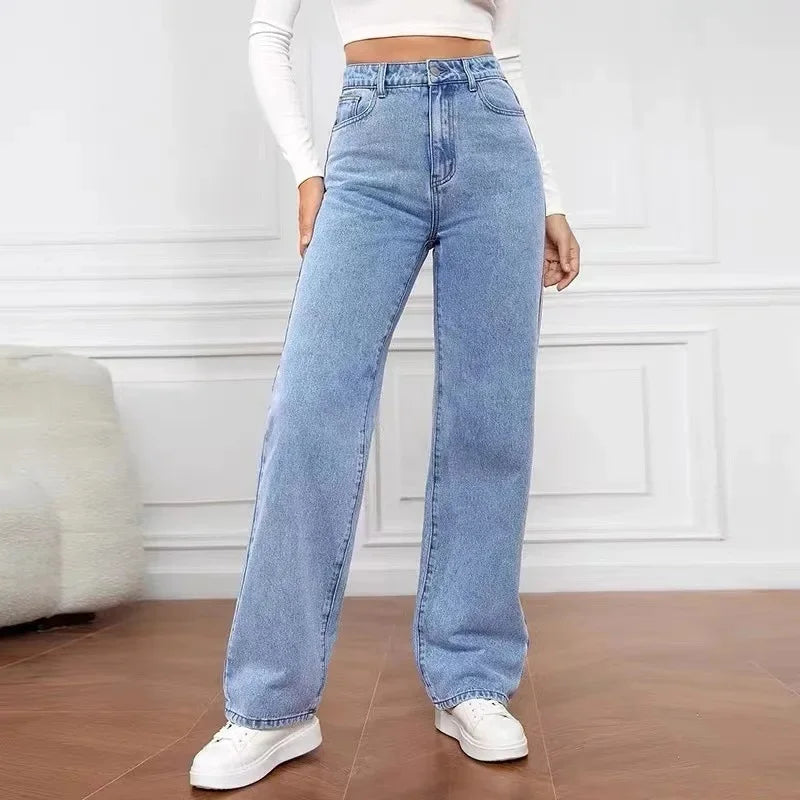 Light blue high-waisted wide-leg denim jeans with a relaxed fit, styled with a fitted white crop top and paired with white sneakers.