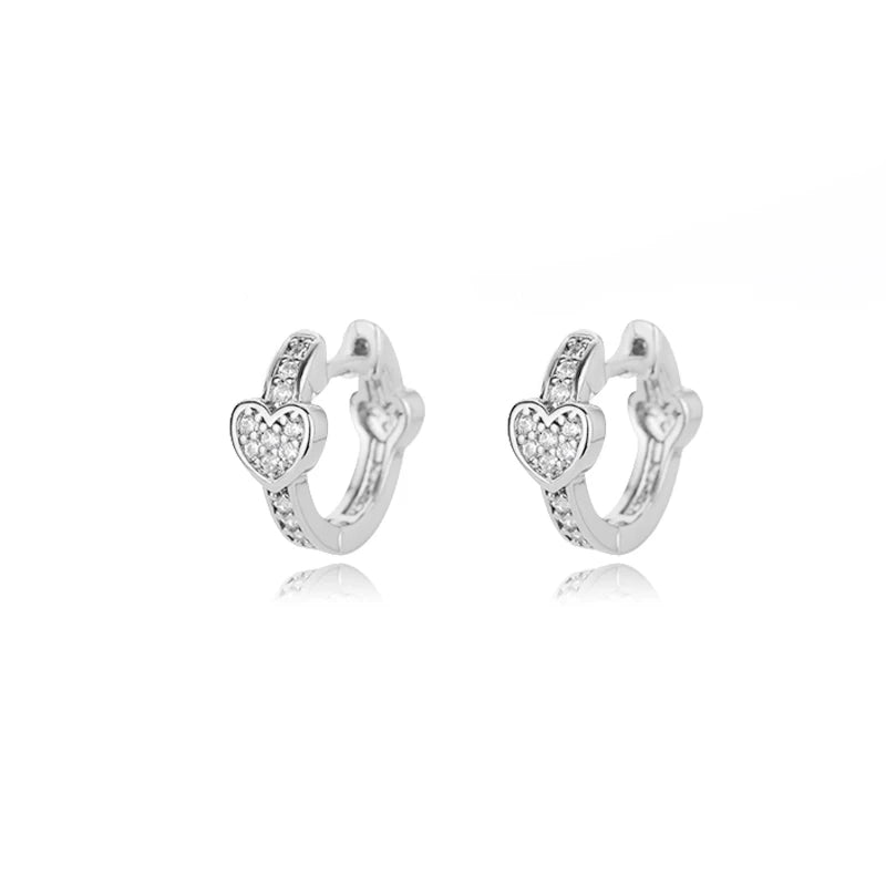 Chunky huggie earrings in stainless steel featuring a heart drop design with sparkling accents.