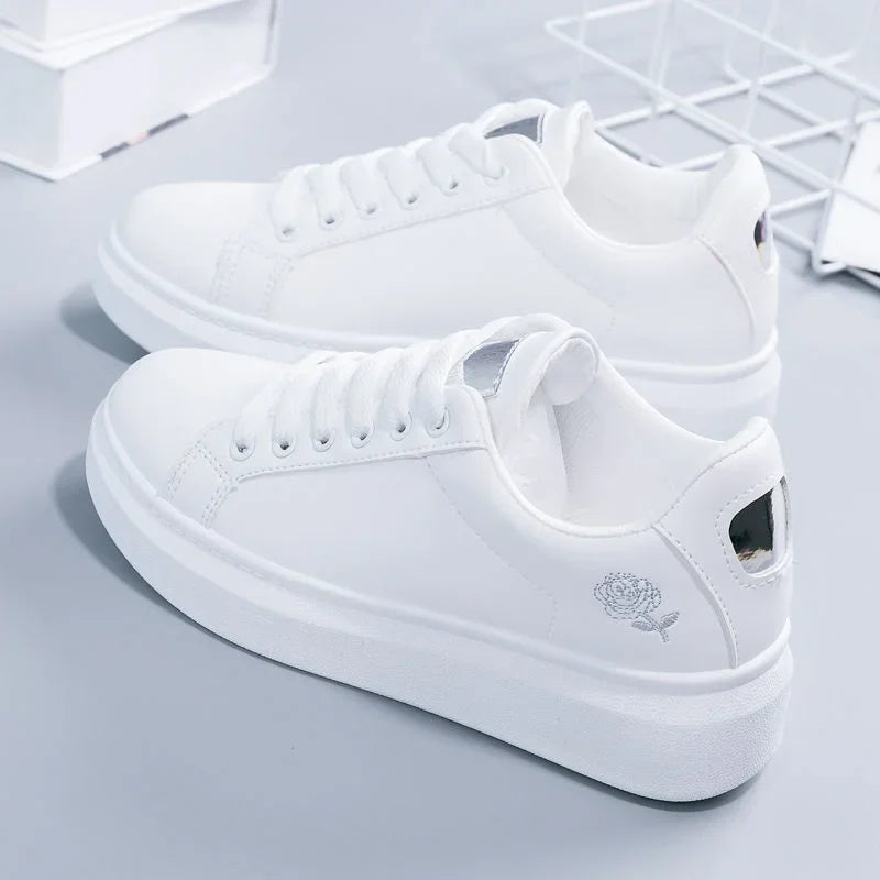 White LOVORA™ Blossom sneakers featuring floral embroidery, lace-up design, and cushioned soles, presented from the side.