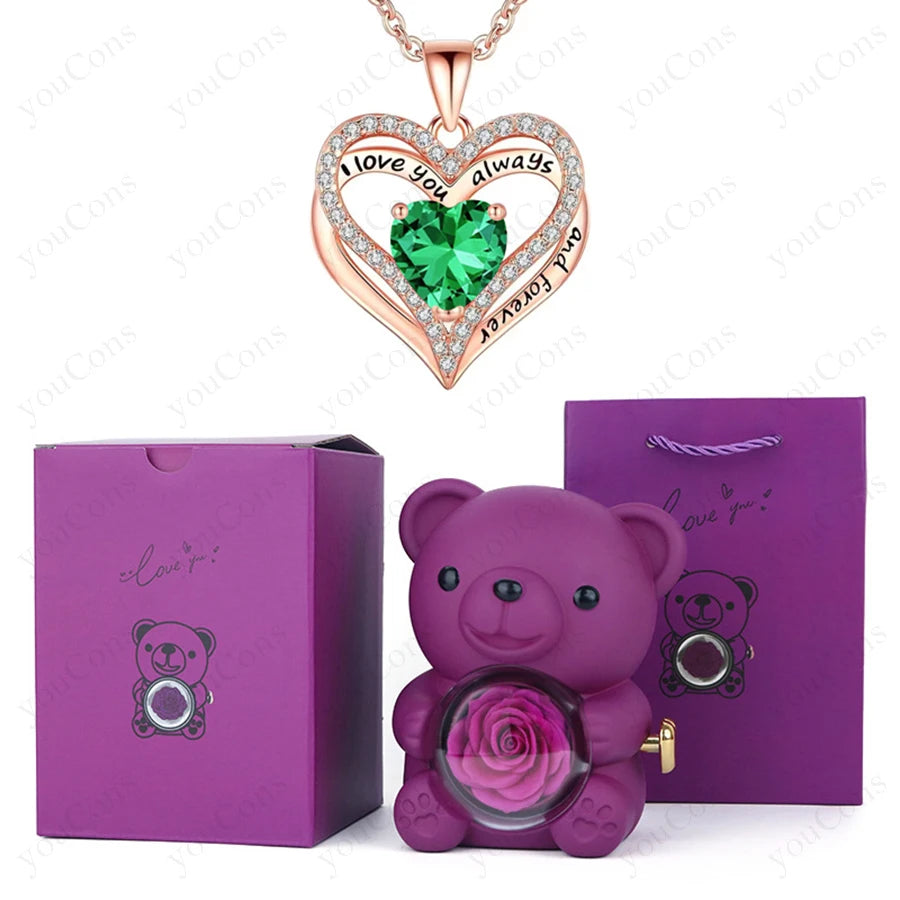 Luxury heart necklace set featuring a green gem heart pendant, a purple bear holder with a preserved rose, and purple gift box.