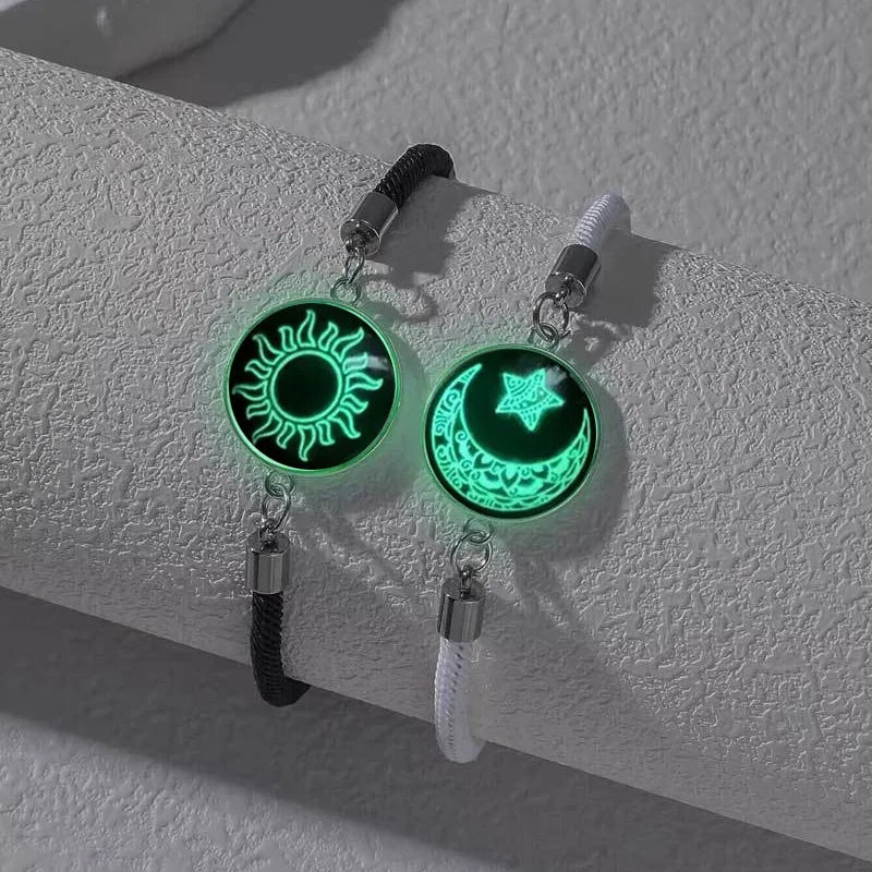 Luminous glow-in-the-dark bracelet set featuring a sun and moon emblem, with black and white rope chains.